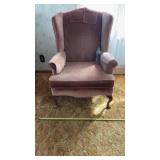 Blush pink velvet wingback armchair featuring