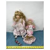 Porcelain dolls with pink attire.