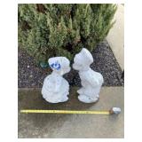 Concrete kissing boy and girl painted statues.