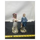 a pair of vintage porcelain figurines depicting