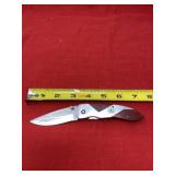 Stainless steel knife with Pioneer Seed logo.