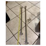Two good curtain rods with hanging brackets.