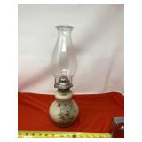 Aladdin oil lamp with gold trimmed flowers.