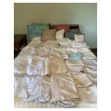 Sheets, pillow cases and pillows on bed.