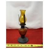 Amber oil lamp with shade.
