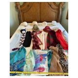 hats and scarves on bed.