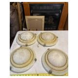 Four wall hugger lights ready to be installed.