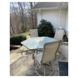 Glass patio table and three chairs