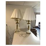 table lamps featuring polished brass columns,