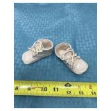 Porcelain baby shoe figurines.