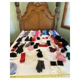 Hats, gloves and ear muffs on bed.
