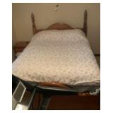 Queen size poster bed with bedding and mattress