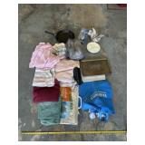 Towels, grocery bags, pan, shower head and cookie