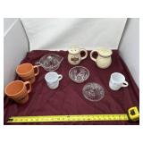 Coffee cups, decorative glass bowls, and cheese