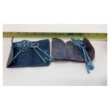 Antique skeleton keys housed in leather holders.