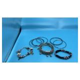 Silver-toned bracelets, including charm