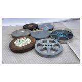 8mm film reels and their metal storage canisters.