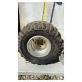 Tire and extra  rim off a Honda 400 EX