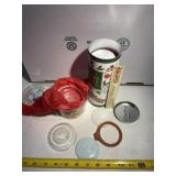 Two containers of vintage canning jar glass lids