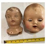 Pair of doll heads with sleepy eyes