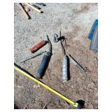 Two grease guns, oil can and tube of grease.