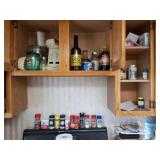 All spices on stove and contents of cabinets.n