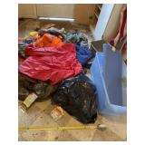 pile of hunting clothes and rain jackets with