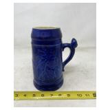 Blue ceramic beer stein .