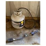 Propane tank over half full with brush burner.