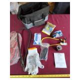 Travel bag with gloves, light and jumper cables.