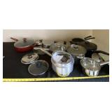 New and used sauce pans with some lids.