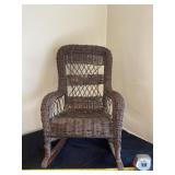Small childï¿½s wicker rocking chair.