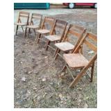 Six vintage fold up wooden chairs.