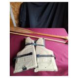 Wood oar and adult universal life jacket.