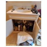 Contents under sink, bath towels and razors.