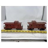 two vintage model train cabooses manufactured by