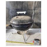 Small Weber charcoal grill.