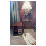 End table with magazine rack and tall lamp .