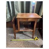End table with drawer and magazine rack.