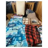 Clothes hamper and blankets and throws.