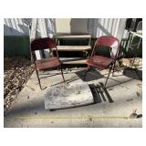 2 red foldable chairs and a small foldable table
