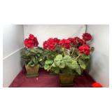 Four containers of artificial red geraniums