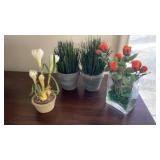 Artificial flowers, one with a glass container