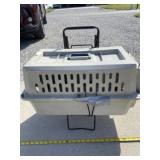 Pet taxi on a stand with wheels and handle.