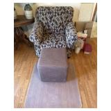 Chair with footstool and plastic mat on floor