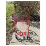 Red push cart on wheels.