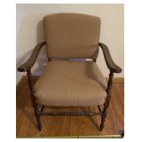 padded armchair brown in color.
