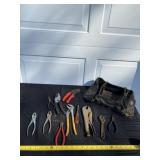 Tool bag, pliers and all tools on table.