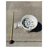 Bucket of golf balls and teeï¿½s