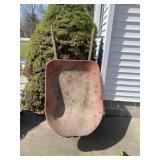 Wheelbarrow with flat tire.